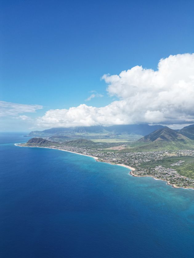 Aerial view of a Hawaiian coastline and mountains