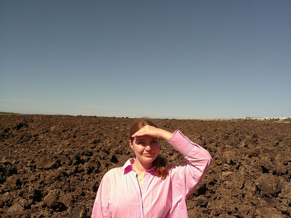 Diana shielding her eyes from the sun on a lava field